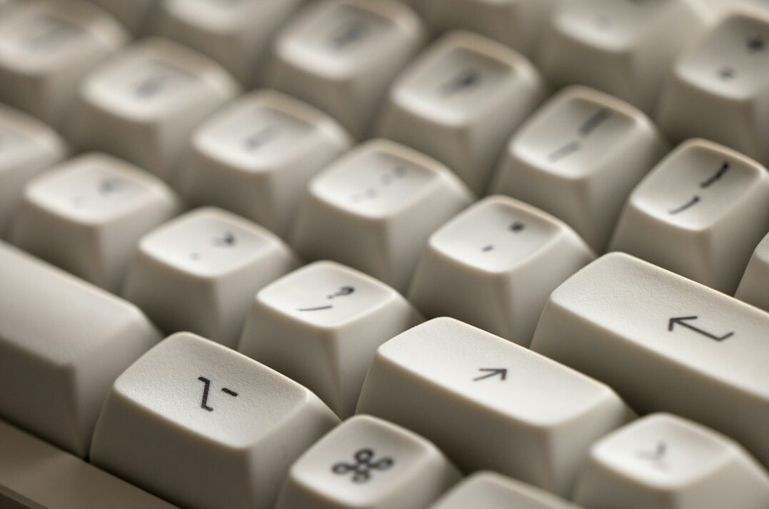 Close-up of hands typing code on a laptop keyboard