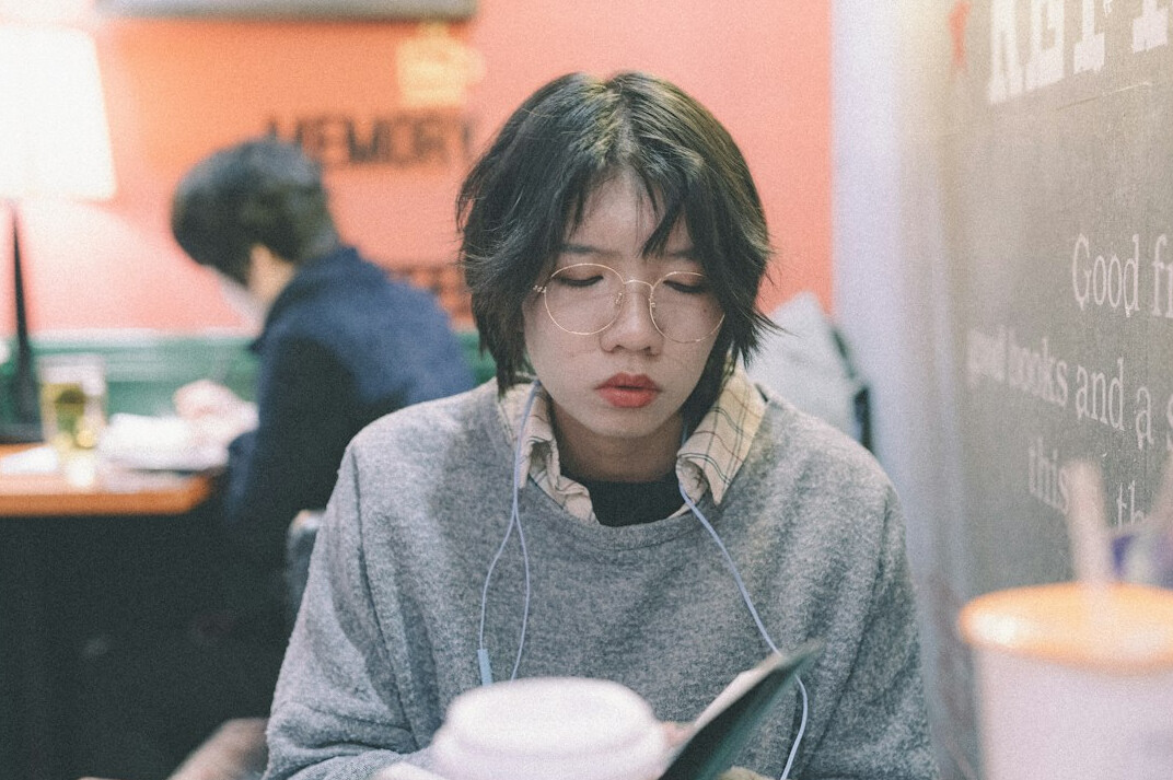 person studying japanese code book
