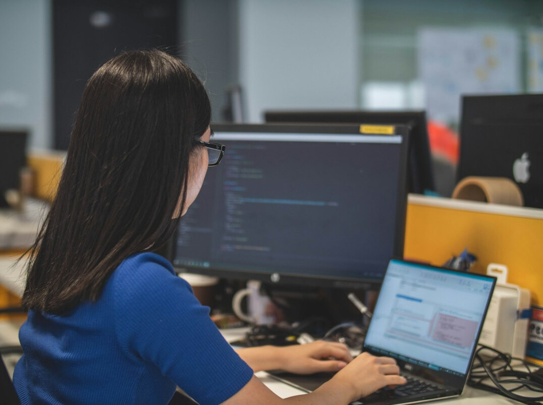bilingual programmer working on laptop
